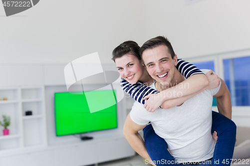 Image of handsome man piggybacking his girlfriend