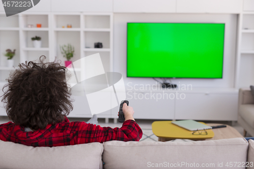 Image of young man in bathrobe enjoying free time