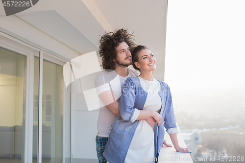 Image of Couple hugging on the balcony