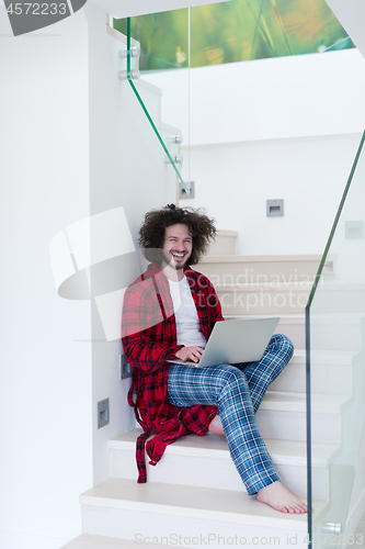 Image of freelancer in bathrobe working from home