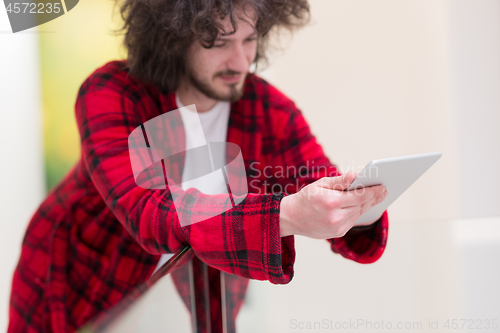 Image of young freelancer using tablet computer