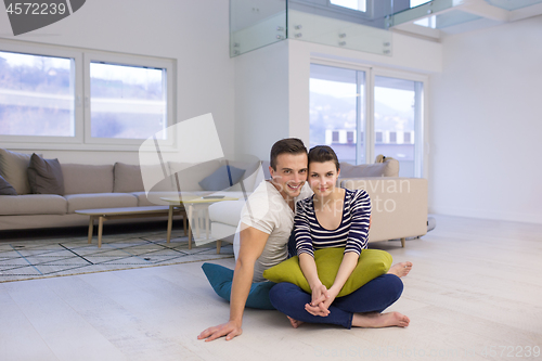 Image of couple sitting on the floor at home