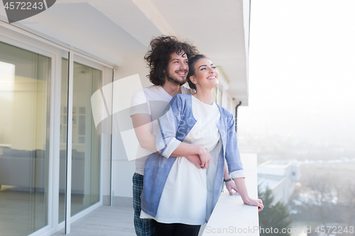 Image of Couple hugging on the balcony