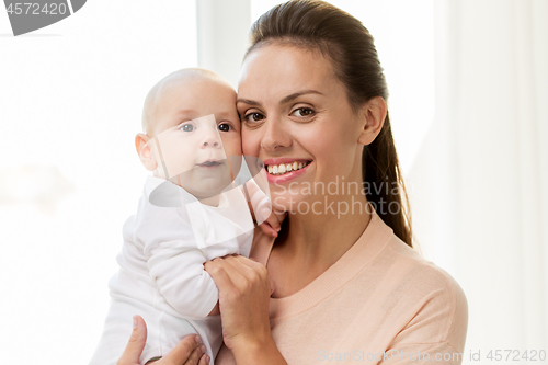 Image of happy mother with little baby boy at home