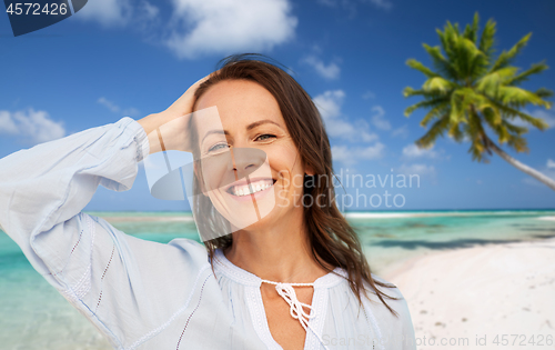 Image of happy smiling woman on summer beach