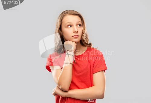 Image of teenage girl in red t-shirt with bangles on arm