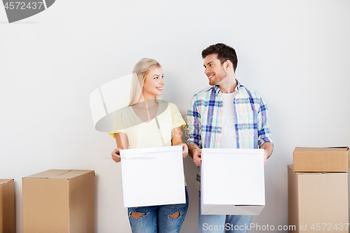 Image of happy couple with boxes moving to new home