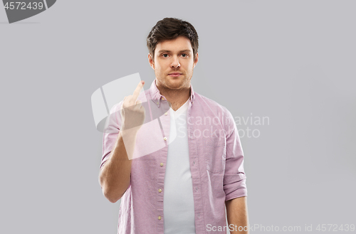 Image of young man over grey background