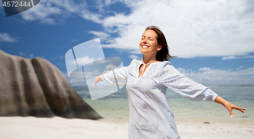 Image of happy woman over seychelles island tropical beach