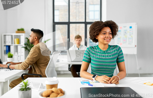 Image of happy smiling african american woman at office