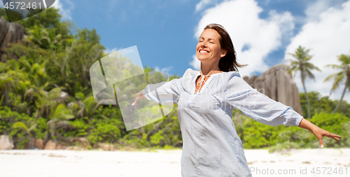 Image of happy woman over seychelles island tropical beach