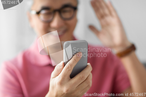 Image of close up of man having video call on smartphone