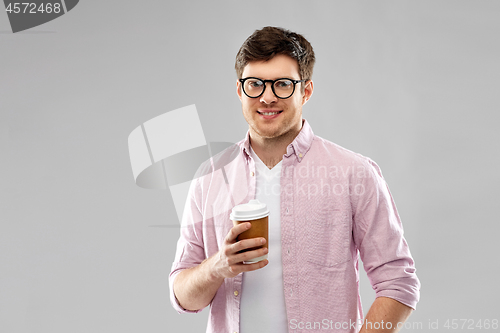 Image of young man or student in glasses drinking coffee