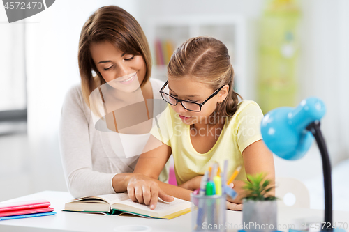 Image of mother and daughter doing homework together