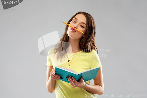 Image of teenage student girl with notebook and pencil