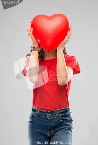 Image of teenage girl with red heart shaped balloon