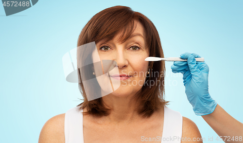 Image of senior woman and surgeon hands with scalpel