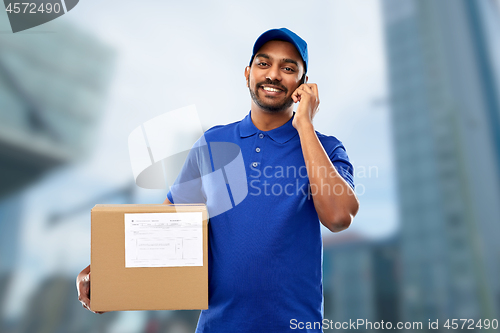 Image of indian delivery man with smartphone and parcel box