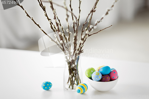 Image of pussy willow branches and colored easter eggs