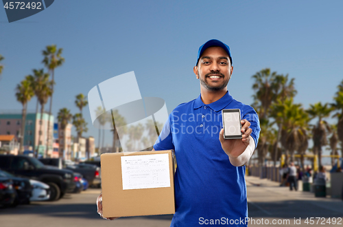 Image of indian delivery man with smartphone and parcel box
