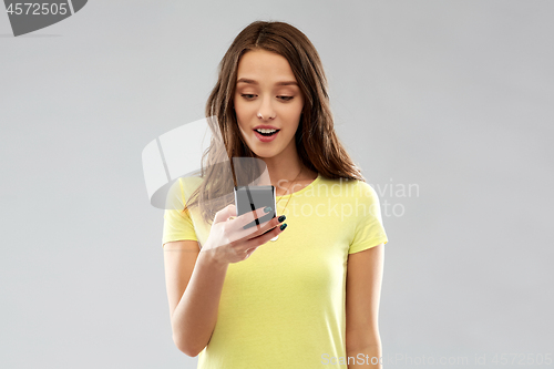 Image of young woman or teenage girl using smartphone