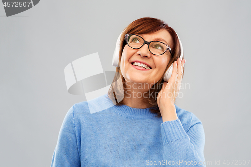 Image of senior woman in headphones listening to music