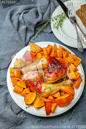 Image of Chicken thighs and baked pumpkin and orange slices.
