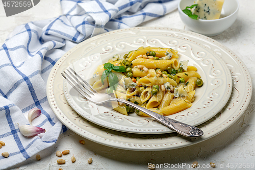 Image of Delicious pasta with green peas and blue cheese.