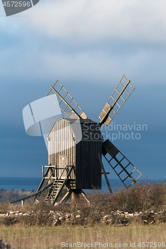 Image of Sunlit old wooden windmill