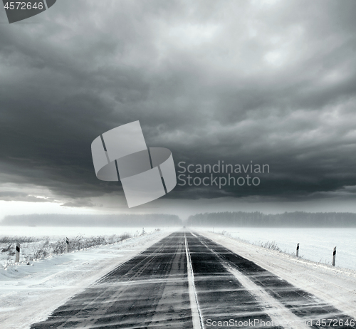 Image of Stormy sky and snow road