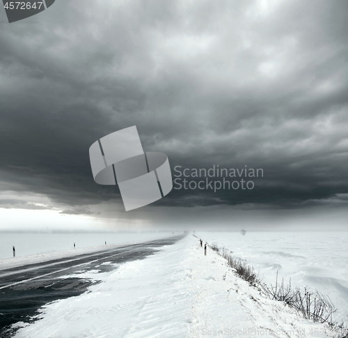 Image of Stormy sky and snow road