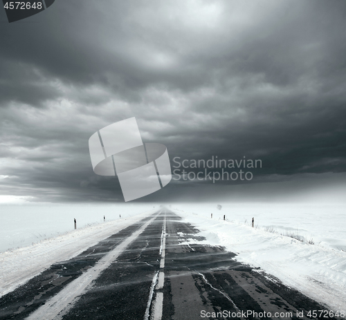 Image of Stormy sky and snow road
