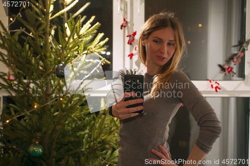 Image of Happy woman making selfie