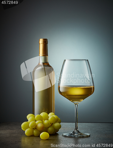 Image of glass and bottle of white wine