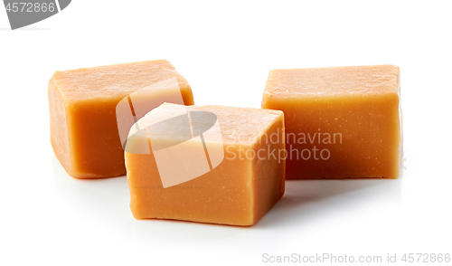 Image of caramel candies on white background