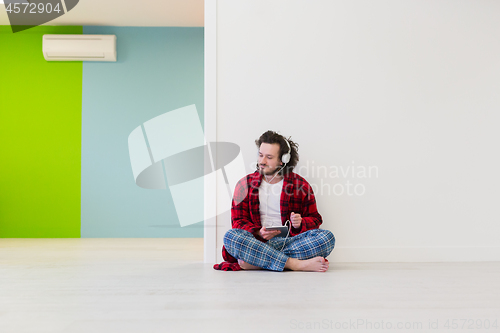 Image of young man enjoying music through headphones