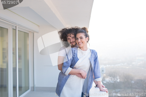 Image of Couple hugging on the balcony