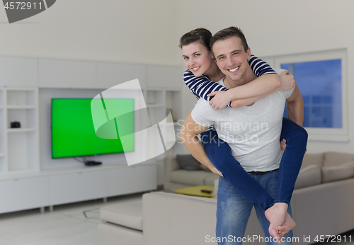 Image of handsome man piggybacking his girlfriend
