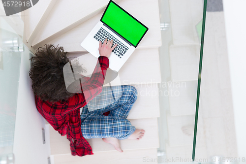 Image of freelancer in bathrobe working from home