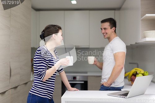 Image of couple with laptop computer enjoying morning