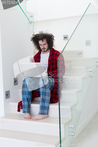 Image of freelancer in bathrobe working from home