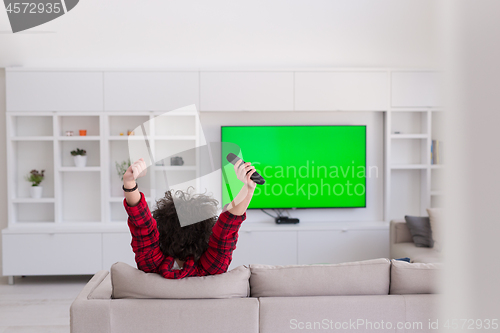 Image of young man in bathrobe enjoying free time