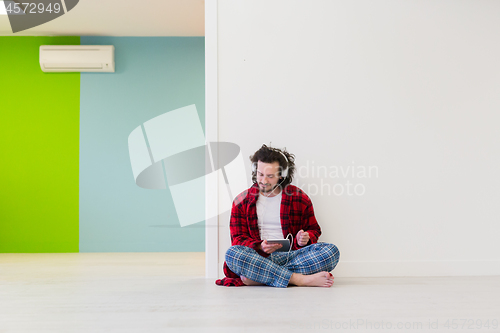 Image of young man enjoying music through headphones