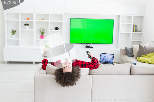 Image of young man in bathrobe enjoying free time