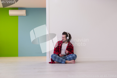 Image of young man enjoying music through headphones