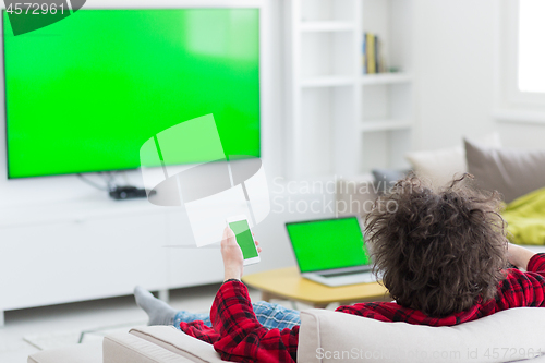 Image of young man in bathrobe enjoying free time