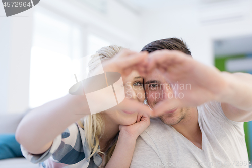 Image of couple making heart with hands