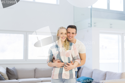 Image of couple hugging in their new home