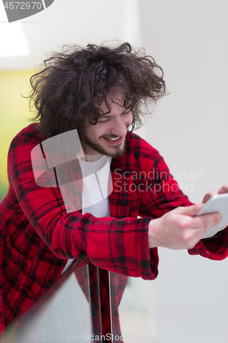 Image of young freelancer using tablet computer