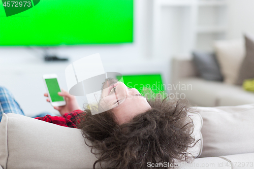 Image of young man in bathrobe enjoying free time